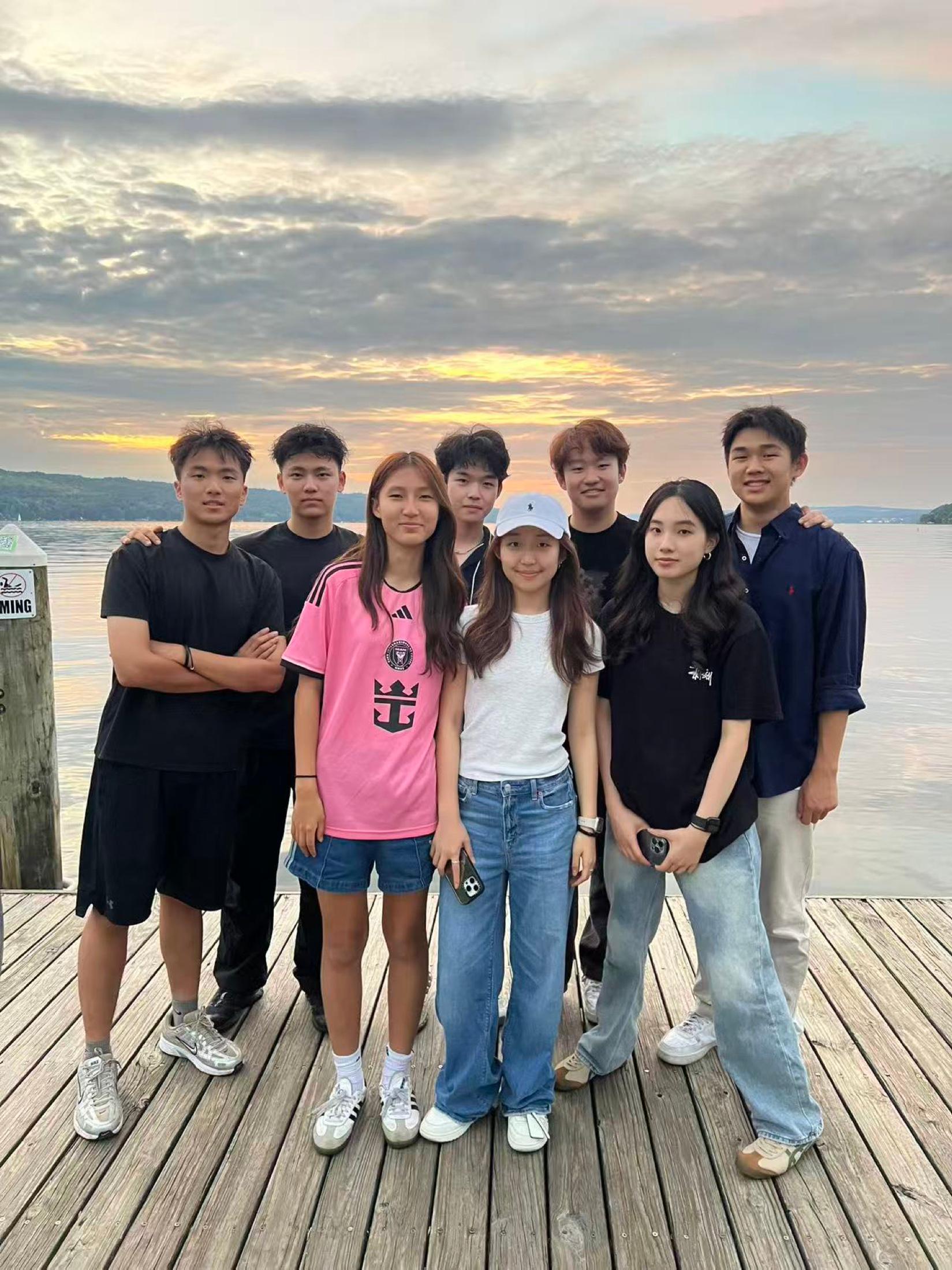 Members posing by the water at BBQ